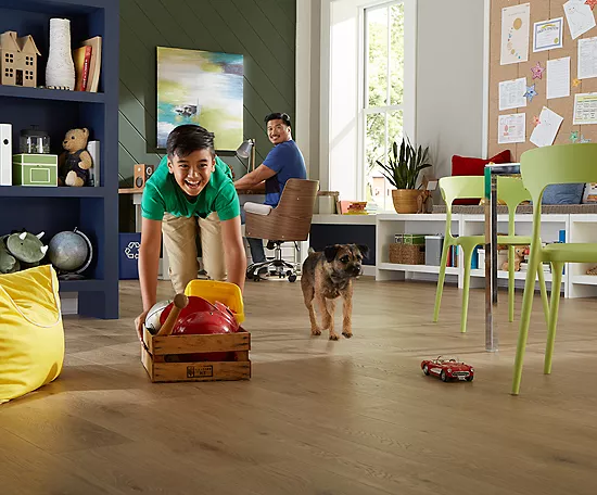 Happy kid playing with puppy | Shans Carpets And Fine Flooring Inc